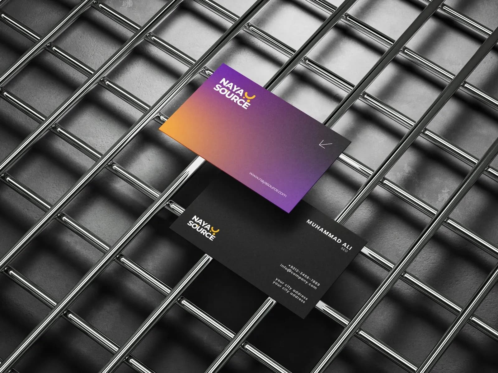 NayaSource business cards in purple and orange gradient on a dark metal grid